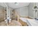 Stunning main bathroom features a soaking tub, glass enclosed shower and tile floor at 2773 Via Cipriani # 1330B, Clearwater, FL 33764