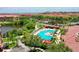 Aerial view of a community pool with cabanas, lounge chairs, and lush landscaping at 2773 Via Cipriani # 1330B, Clearwater, FL 33764