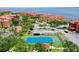 Aerial view of tennis court surrounded by red-roofed condos and lush landscaping at 2773 Via Cipriani # 1330B, Clearwater, FL 33764