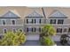 Townhomes with a neutral exterior featuring well-maintained landscaping at 31 Estuary Trl, Clearwater, FL 33759