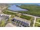 Stunning aerial perspective of the condo community, near a waterway, amidst lush greenery and a coastal atmosphere at 31 Estuary Trl, Clearwater, FL 33759