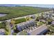 Panoramic aerial view of the townhomes with beautiful landscaping, trees, and an outdoor park at 31 Estuary Trl, Clearwater, FL 33759