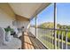 Inviting screened balcony features ample seating, perfect for enjoying the water view at 31 Estuary Trl, Clearwater, FL 33759