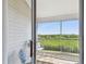 Cozy screened balcony features seating with views of lush greenery and city skyline at 31 Estuary Trl, Clearwater, FL 33759