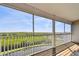 Enjoy tranquil views from the spacious screened balcony overlooking a serene canal and lush landscaping at 31 Estuary Trl, Clearwater, FL 33759