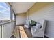 Relax on this covered balcony with comfortable wicker seating and peaceful neighborhood views at 31 Estuary Trl, Clearwater, FL 33759