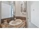 Well-lit bathroom with a marble countertop and a white sink, providing a clean and functional space at 31 Estuary Trl, Clearwater, FL 33759