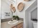 Neutral powder room with a sink and decorative artwork at 31 Estuary Trl, Clearwater, FL 33759