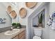 Neutral powder room with a decorative mirror, artwork, and a sink at 31 Estuary Trl, Clearwater, FL 33759