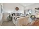 Stylishly decorated bedroom with a comfortable bed, accent chair, and a balcony at 31 Estuary Trl, Clearwater, FL 33759