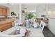 Dining table positioned between the kitchen and a bright living area with natural light at 31 Estuary Trl, Clearwater, FL 33759