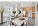 Charming dining area featuring stylish furnishings, natural light, and a view of the modern kitchen for cozy meals at 31 Estuary Trl, Clearwater, FL 33759
