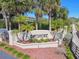 Bayshore community entrance sign surrounded by lush landscaping and palm trees, creating a welcoming and attractive entryway at 31 Estuary Trl, Clearwater, FL 33759