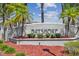 Well-maintained Bayshore sign with vibrant landscaping and stately palm trees creates an inviting entry at 31 Estuary Trl, Clearwater, FL 33759