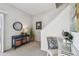 Cozy foyer featuring a console table, wall art, and a stylish chair with stairs to the upper level at 31 Estuary Trl, Clearwater, FL 33759