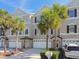 Charming townhome featuring a two-car garage, neutral exterior, and well-maintained landscaping at 31 Estuary Trl, Clearwater, FL 33759