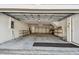 Spacious two-car garage with storage shelves, white walls and concrete flooring at 31 Estuary Trl, Clearwater, FL 33759