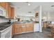 Bright kitchen featuring an island and a breakfast bar overlooking the living area at 31 Estuary Trl, Clearwater, FL 33759