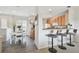 Bright dining area and breakfast bar connected to a kitchen with modern appliances, creating a cozy and functional living space at 31 Estuary Trl, Clearwater, FL 33759