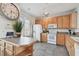 Well-lit kitchen equipped with modern appliances, ample cabinet space, and a breakfast bar for convenient meal preparation at 31 Estuary Trl, Clearwater, FL 33759