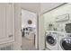 Convenient laundry area with modern appliances, offering space and functionality near the bedroom at 31 Estuary Trl, Clearwater, FL 33759