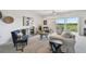 Well-decorated living room with comfortable seating, tasteful artwork, and sliding doors leading to a balcony with outdoor views at 31 Estuary Trl, Clearwater, FL 33759