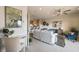Bright living room, with a couch, and a desk space adjacent to the open-concept kitchen and bar at 31 Estuary Trl, Clearwater, FL 33759