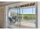 Inviting screened patio featuring comfortable seating and a table, with a view of the surrounding scenery at 31 Estuary Trl, Clearwater, FL 33759