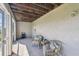 Cozy patio featuring two comfortable wicker chairs, an outdoor fan, and screened-in windows at 31 Estuary Trl, Clearwater, FL 33759