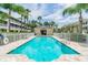 Bayshore community pool featuring clear blue water, poolside seating, and lush tropical landscaping creating a serene oasis at 31 Estuary Trl, Clearwater, FL 33759
