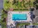 Aerial view of the community pool with tables and lounge chairs, perfect for relaxation in a private setting at 31 Estuary Trl, Clearwater, FL 33759