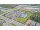 A beautiful aerial view of community amenities including the pool, clubhouse, and tennis courts at 32684 Tamarind Grove Ln, Wesley Chapel, FL 33543