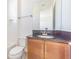 Bathroom showcasing a granite countertop, a framed mirror, and a sink with a brushed nickel faucet at 32684 Tamarind Grove Ln, Wesley Chapel, FL 33543