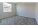 Cozy bedroom with a large window and plush neutral carpeting at 32684 Tamarind Grove Ln, Wesley Chapel, FL 33543