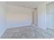 This bedroom features neutral carpet, white walls, and a walk-in closet ready to be filled at 32684 Tamarind Grove Ln, Wesley Chapel, FL 33543