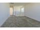 Upstairs hallway with neutral carpeting and access to multiple rooms and natural light at 32684 Tamarind Grove Ln, Wesley Chapel, FL 33543