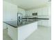 Bright kitchen with large kitchen island, modern stainless steel appliances, and white cabinets at 32684 Tamarind Grove Ln, Wesley Chapel, FL 33543