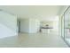 Spacious open-concept living room and kitchen area with tile flooring and plenty of natural light at 32684 Tamarind Grove Ln, Wesley Chapel, FL 33543