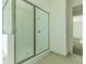 Modern glass enclosed shower featuring tiled walls and a bright interior in the main bathroom at 32684 Tamarind Grove Ln, Wesley Chapel, FL 33543