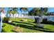 Spacious backyard with well-maintained lawn, fire pit, and white picket fence at 3506 Moog Rd, Holiday, FL 34691