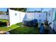 Secluded backyard area with hot tub and privacy fence surrounded by well-kept lawn at 3506 Moog Rd, Holiday, FL 34691