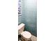 Quaint blue tiled bathroom features an efficient toilet at 3506 Moog Rd, Holiday, FL 34691
