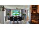 Bright dining room features swan-themed stained glass windows and a modern chandelier and stylish decor at 3506 Moog Rd, Holiday, FL 34691
