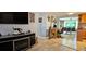 View of the open concept living room into a dining space with tile and laminate flooring at 3506 Moog Rd, Holiday, FL 34691