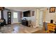 Spacious open concept living room with laminate flooring, tv, and a decorative fireplace at 3506 Moog Rd, Holiday, FL 34691