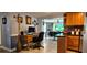 View of the open concept living room into a dining space with tile and laminate flooring at 3506 Moog Rd, Holiday, FL 34691