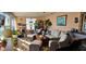Cozy sunroom with tile floors, comfortable seating, and an abundance of natural light and plants at 3506 Moog Rd, Holiday, FL 34691