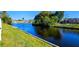 Scenic water view features lush greenery and a tranquil canal in a residential area at 3506 Moog Rd, Holiday, FL 34691