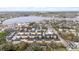 Aerial view of a neighborhood with new homes and a scenic lake in the distance at 423 Shaddock St, Tarpon Springs, FL 34689