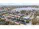 Aerial view of a lakeside community with colorful homes and mature trees at 423 Shaddock St, Tarpon Springs, FL 34689